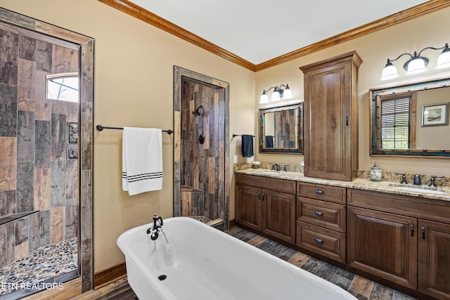 bathroom with a freestanding tub, wood finished floors, a sink, tiled shower, and crown molding