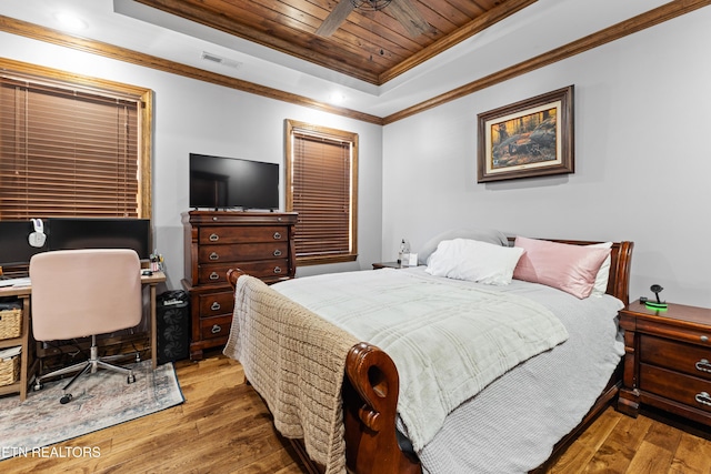 bedroom with wood ceiling, a raised ceiling, visible vents, and hardwood / wood-style floors