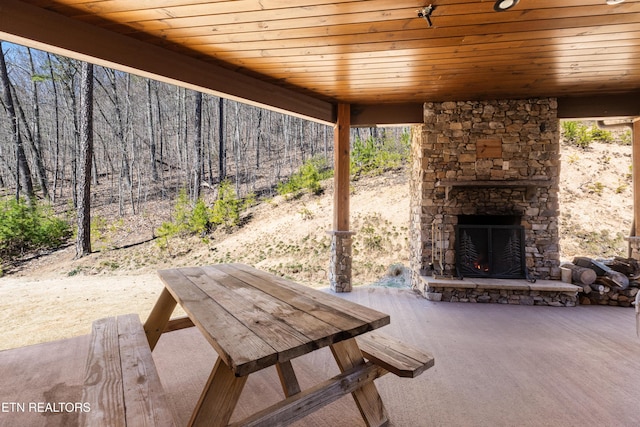 view of patio featuring an outdoor stone fireplace