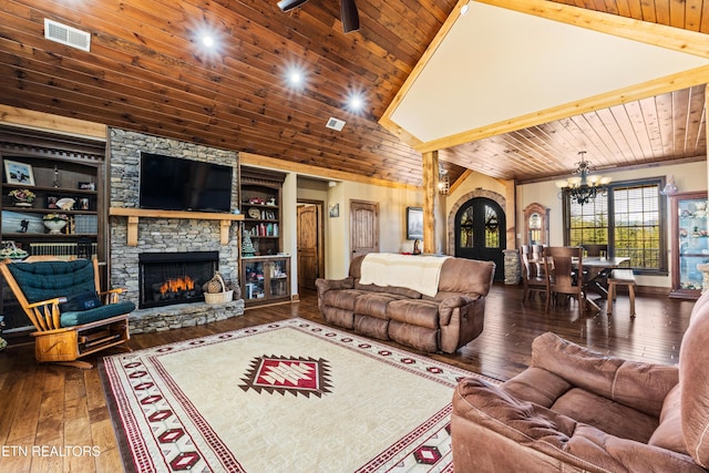 living room with visible vents, wood ceiling, wood-type flooring, an inviting chandelier, and a stone fireplace