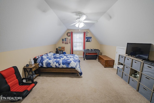 carpeted bedroom featuring lofted ceiling and ceiling fan