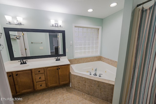 bathroom with tile patterned floors, a sink, a jetted tub, and double vanity