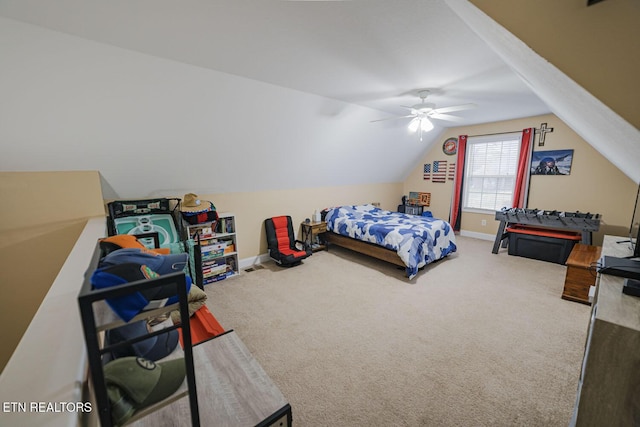 carpeted bedroom with ceiling fan, baseboards, and vaulted ceiling