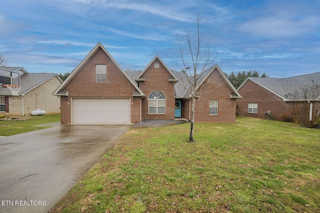 traditional-style house with a garage, a front yard, concrete driveway, and brick siding