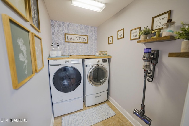 clothes washing area with laundry area, independent washer and dryer, and baseboards