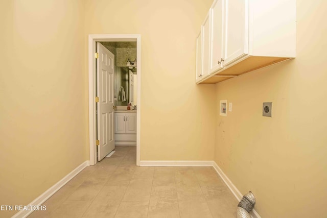 clothes washing area featuring light tile patterned floors, hookup for a washing machine, cabinet space, electric dryer hookup, and baseboards