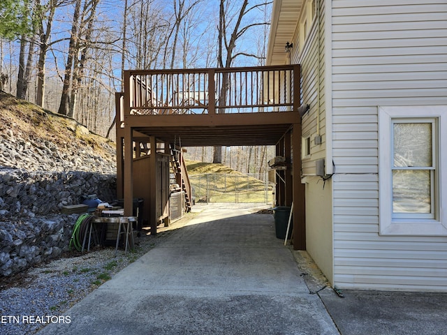 view of property exterior featuring stairway and a wooden deck