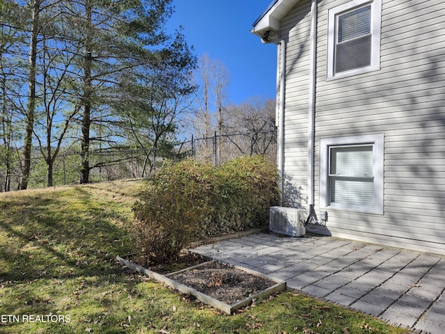 view of yard with a patio area, fence, and ac unit