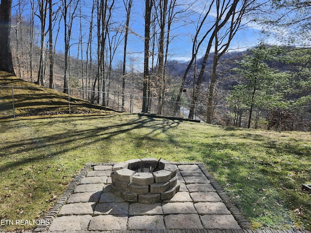 view of yard featuring a fire pit and fence