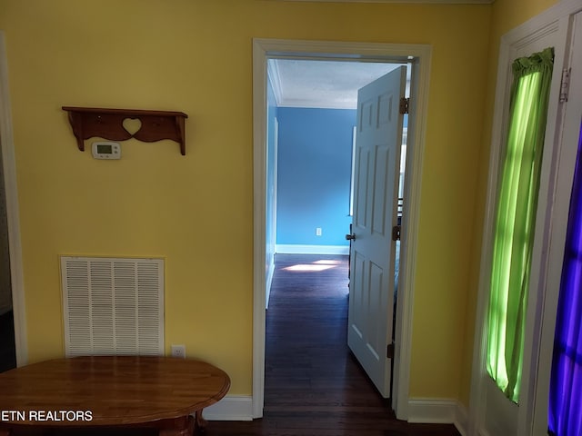 corridor with visible vents, dark wood finished floors, and baseboards