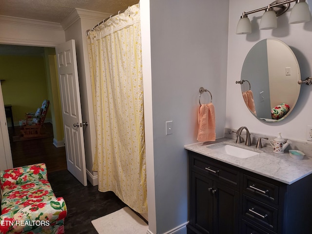 full bathroom featuring baseboards, wood finished floors, vanity, and crown molding