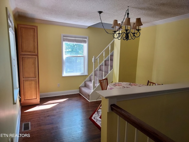 interior space with visible vents, stairway, ornamental molding, dark wood-style flooring, and a chandelier