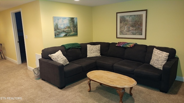 carpeted living area with visible vents and baseboards