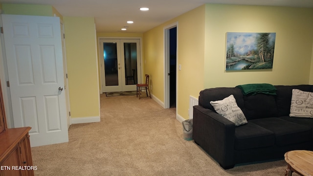 living area with recessed lighting, french doors, light carpet, and baseboards