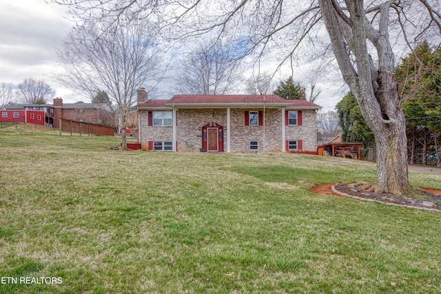 view of front of house with a chimney and a front lawn