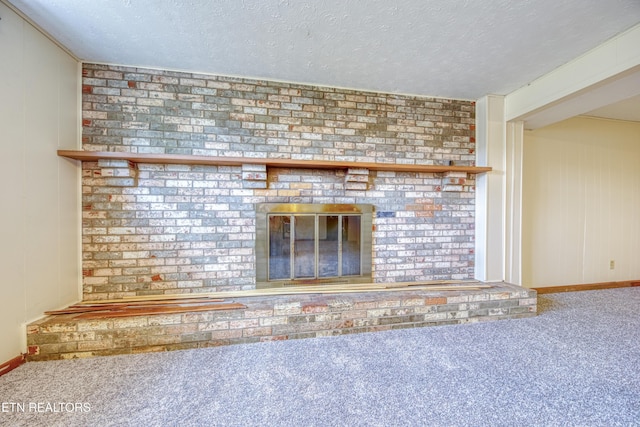 room details with carpet floors, a fireplace, baseboards, and a textured ceiling