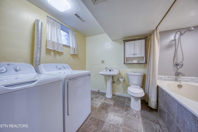 clothes washing area with laundry area, baseboards, visible vents, washer and dryer, and a sink