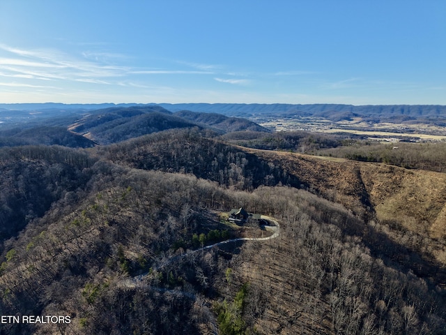 drone / aerial view with a forest view and a mountain view