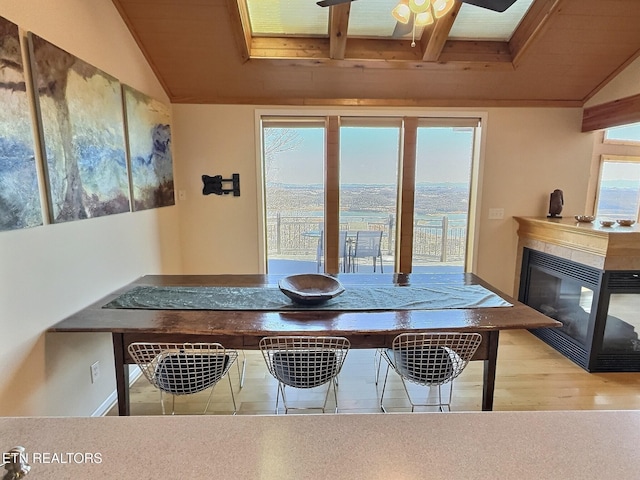 dining space featuring lofted ceiling, a wealth of natural light, and a ceiling fan