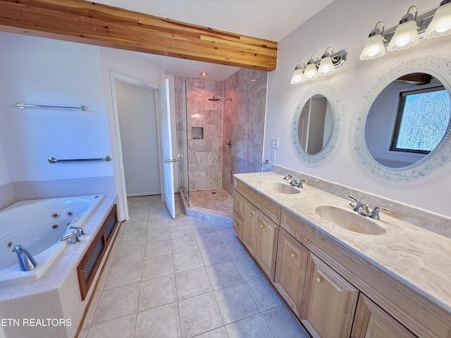 full bathroom featuring a jetted tub, a shower stall, a sink, and tile patterned floors