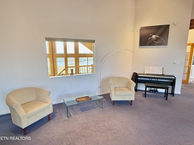 sitting room featuring carpet flooring and baseboards