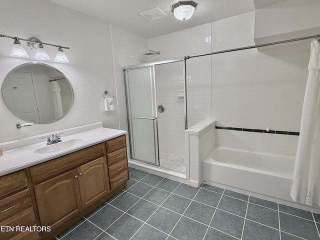 full bath featuring a textured wall, vanity, a bath, tile patterned floors, and a stall shower