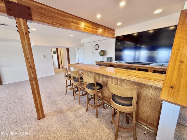 bar with light carpet, indoor bar, beam ceiling, and recessed lighting