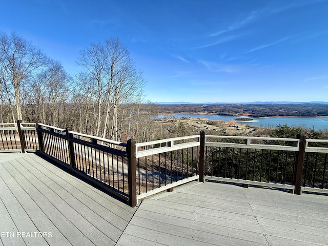 wooden terrace featuring a water view