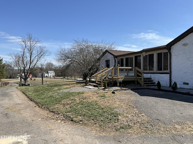 view of home's exterior with a wooden deck