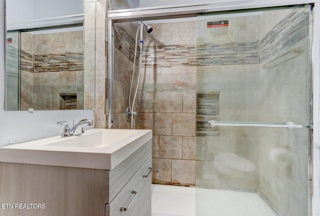 full bathroom featuring vanity and a shower stall