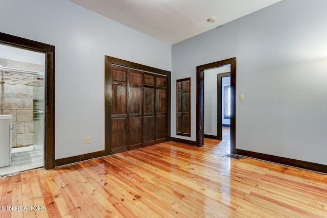 unfurnished bedroom with light wood finished floors, visible vents, and baseboards