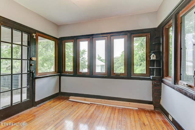 empty room with light wood finished floors and baseboards