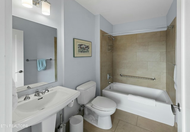 bathroom featuring a sink, toilet, shower / bathtub combination, and tile patterned flooring