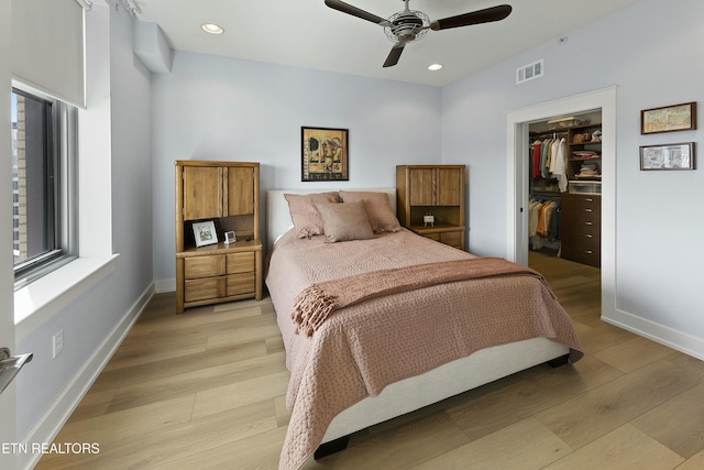 bedroom with baseboards, visible vents, recessed lighting, a spacious closet, and light wood-type flooring