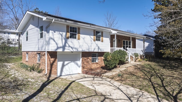 view of front of house with an attached garage, covered porch, concrete driveway, and brick siding