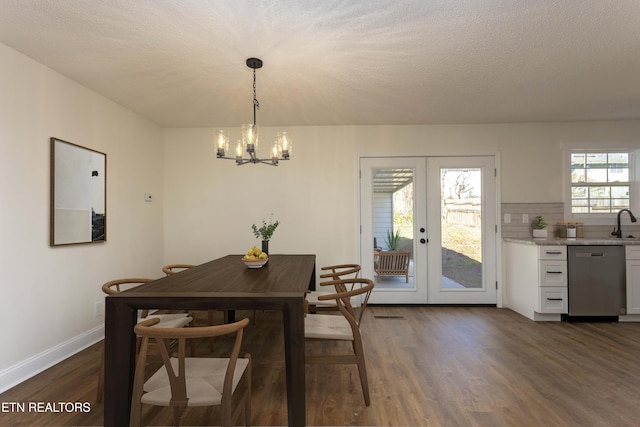 dining area featuring dark wood-style floors, french doors, a textured ceiling, and baseboards