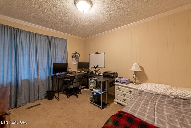 bedroom with a textured ceiling, visible vents, crown molding, and carpet flooring