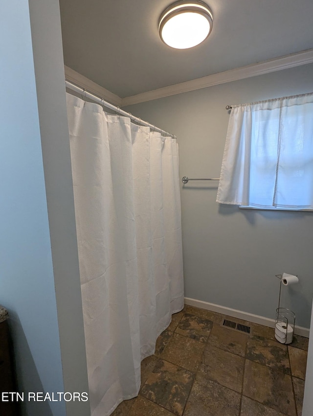 full bath with baseboards, visible vents, ornamental molding, curtained shower, and stone tile flooring