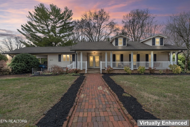 view of front facade with french doors, a porch, a front yard, and a shingled roof