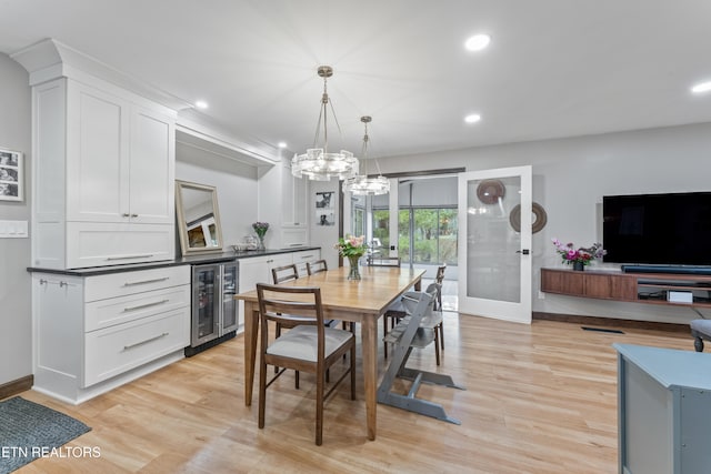 dining area featuring beverage cooler, light wood-style flooring, and recessed lighting