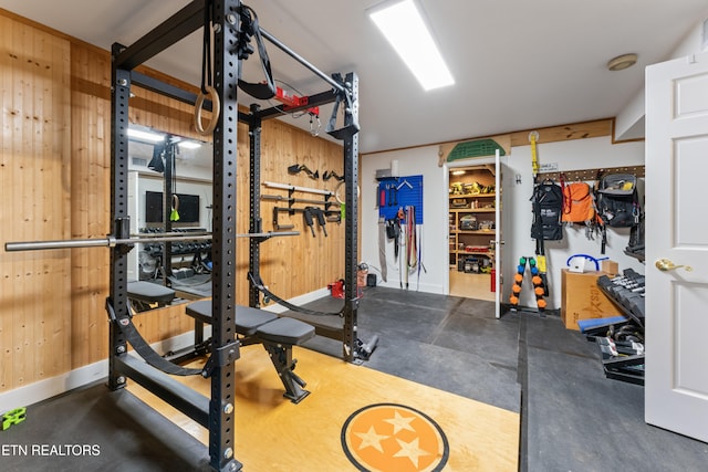 workout area featuring wood walls