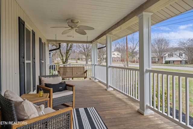 wooden deck with covered porch and a ceiling fan