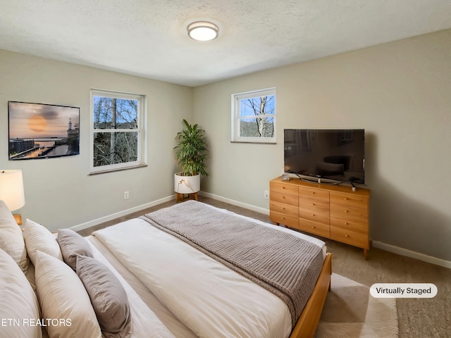 bedroom with baseboards and a textured ceiling