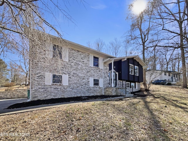 view of property exterior with brick siding