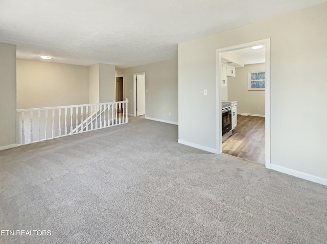 carpeted spare room with baseboards