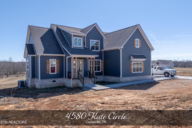 view of front of home featuring central AC unit and roof with shingles