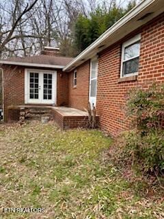 view of side of property with brick siding