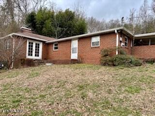 exterior space with brick siding