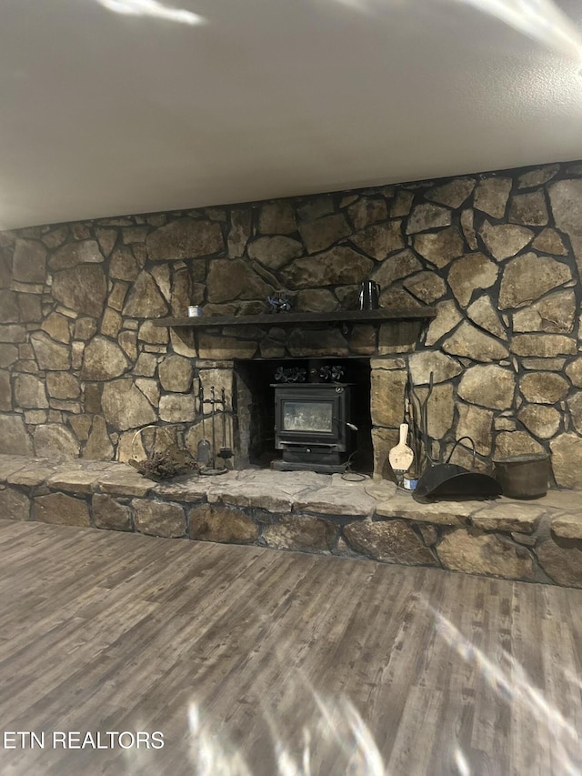 details with wood finished floors and a wood stove