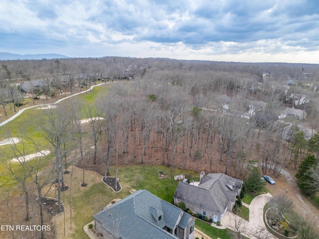 birds eye view of property with a wooded view